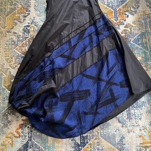 Unique asymmetric black dress with blue accents.